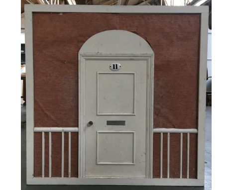 A vintage wendy house, made up of three sides in the style of a Victorian terrace, each panel 117cm square 