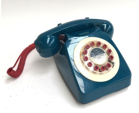 A vintage blue and red rotary dial telephone 