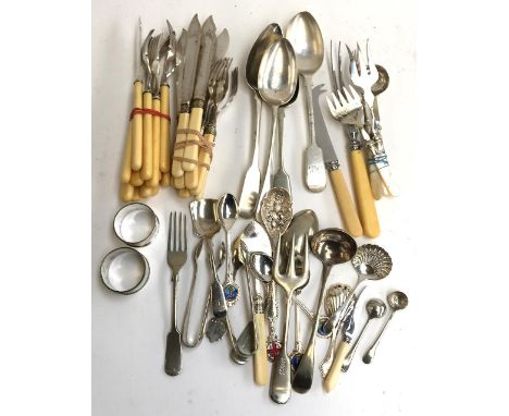 A large quantity of plated flatware to include fruit knives and forks, spoons, a shell caddy spoon, etc 