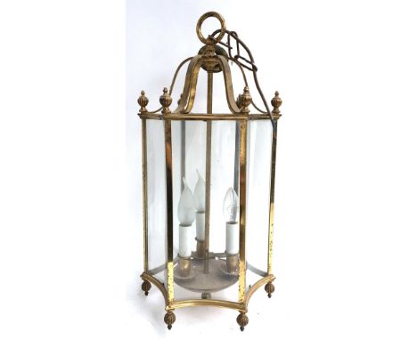A gilt metal ceiling lantern, hexagonal form with concave glass panels, and three light fitting, approximately 55cmH 