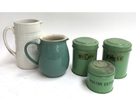 Three green enamel jars labelled 'Sultanas', 'Raisins', and 'Pastry Cutters'; together with a Denby jug and one other