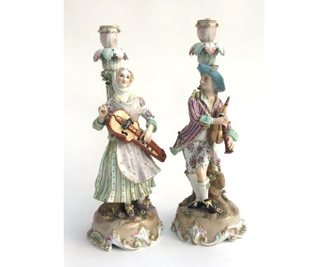 A pair of Meissen (?) candlestick figures, late 19th century in the form of musicians, cross swords to base along with impres