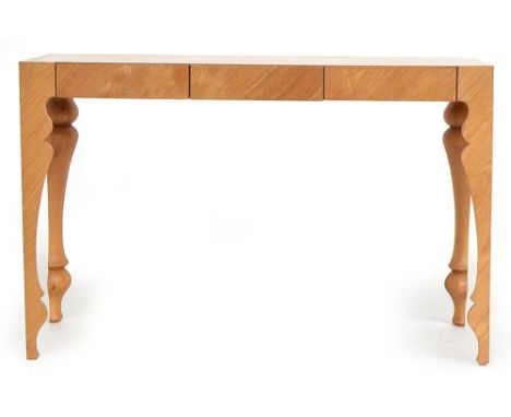 A contemporary console table designed by John Reeves for Heal's, made in oak and oak veneered with three flush drawers and sh