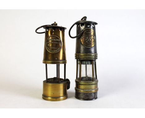 An Ackroyd & Best miners lamp.  Height excluding handle 27 cm, together with The Protector Lamp & Lighting Company miners lam