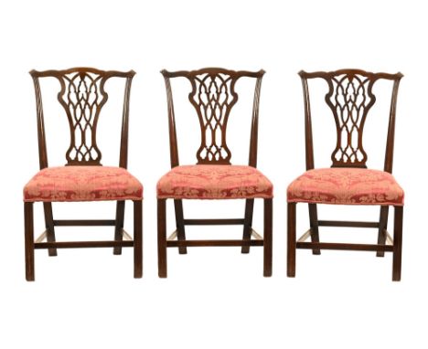 A set of three George III Chippendale style splat back dining chairs, with yoke shaped top rails, pierced and carved splats a