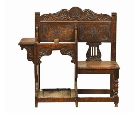 A late Victorian oak combined hall seat and stick stand, with carved pediment and edge.  Height 104 cm, width 109 cm, depth 3