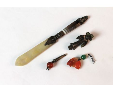 A Chinese silver coloured metal figure of a man, with hardstone drop and jade and hardstone pendant, together with an agate l