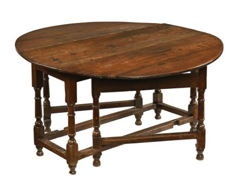 A Georgian oak gate leg table, raised on turned and square section legs.  Height 73 cm, width 132 cm, length flaps up 144 cm.