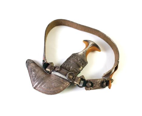 A silver coloured metal mounted Khanjar Omani dagger.  Overall length including scabbard 29 cm and complete with belt. This b