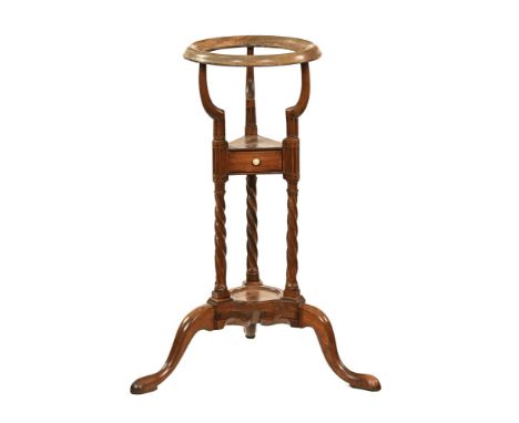 A George III mahogany kettle stand, with circular top single drawer and low shelf and all raised on downswept legs terminatin