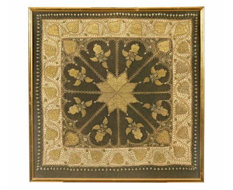 A framed Eastern tablecloth, decorated with fruiting vines and with gold coloured thread in a gilt frame.  Frame size 84 x 84