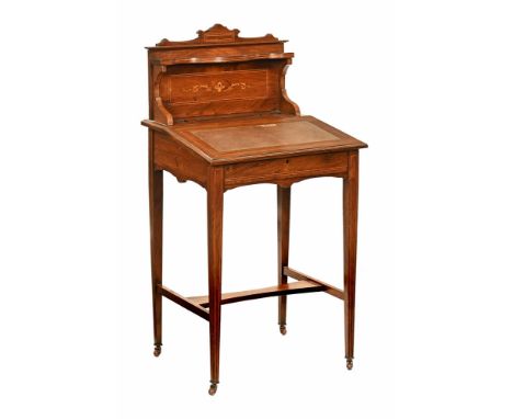 An Edwardian inlaid writing desk, with upstand with shelf, the base with apertures for pen and inkwell and with slanted toole
