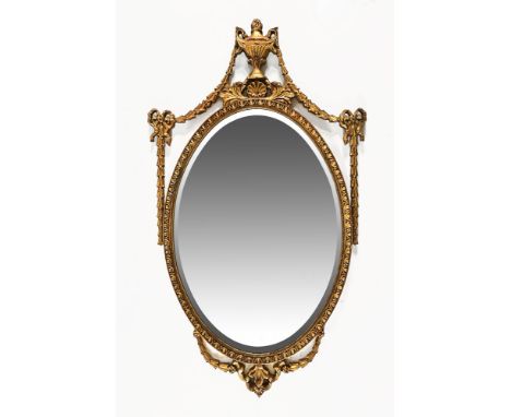 A gilt wood oval bevel edge mirror, frame having urn and swag decoration.  Frame size 104 cm x 60 cm, mirror size 67 cm x 46 