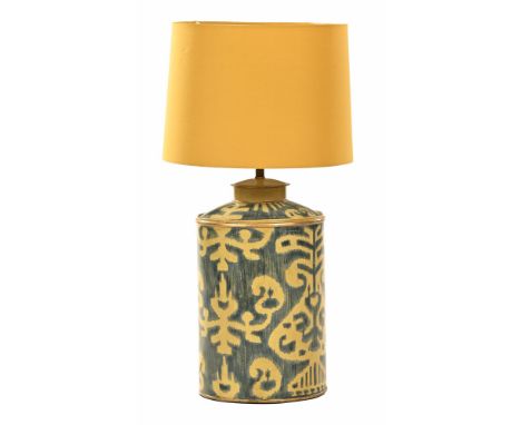 An OKA painted tin lamp base, with yellow shade.  Height excluding shade 40 cm.   CONDITION REPORT:  We can see no signs of a