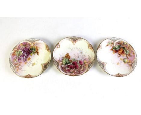 Three Royal Worcester fruit decorated pierced plates, each with puce mark and registration number verso.  Diameter 22 cm.   C