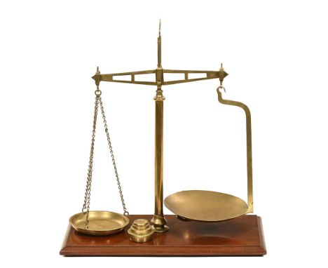 A set of brass balance scales by Parnall & Sons Bristol, with four solid brass weights.  Height 58 cm, base 51 cm x 25 cm.