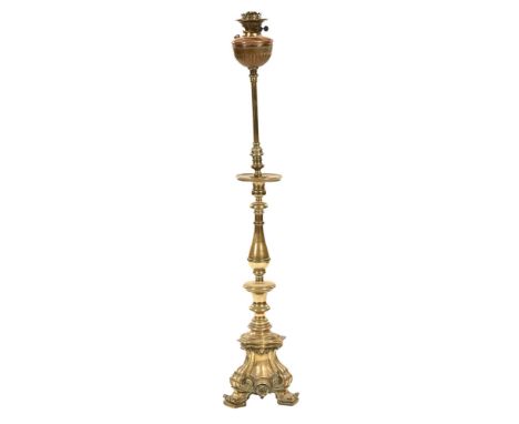 A 19th century brass pricket candlestick, with later oil lamp attached.  Height to top of pricket 81 cm, overall height inclu