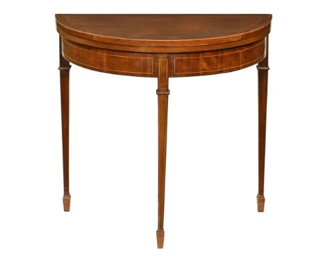 An Edwardian inlaid mahogany turnover top card table, with recessed frieze and raised on tapered legs of square section termi