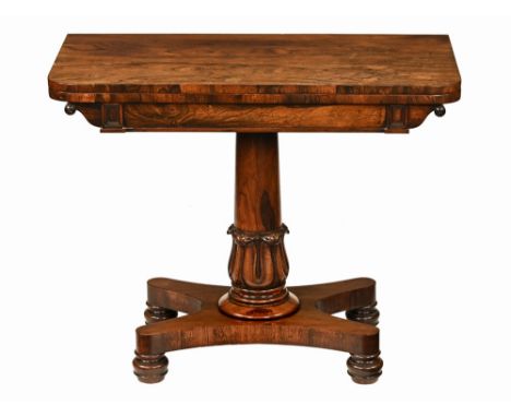 A William IV rosewood turnover top card table, with rounded corners and recessed frieze raised on a turned stylised tulip car