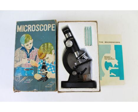 A vintage students microscope, in original box with slides and instructions.