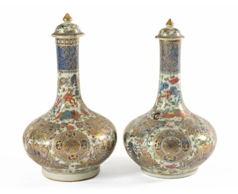 A pair of late 19th century Chinese lidded bottle shaped vases, with blue decoration and gilded overlay.  Height 48 cm and 38