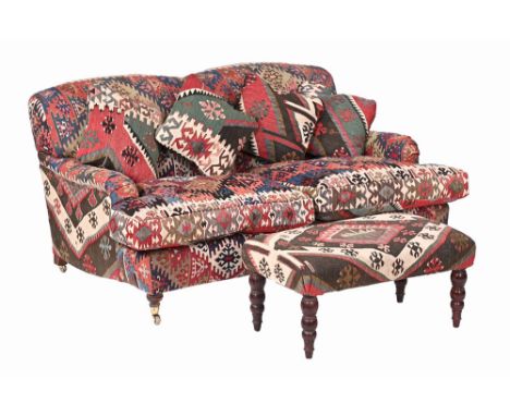 A modern two seater settee, in the traditional style upholstered in Killim carpet and complete with footstool.  Settee height