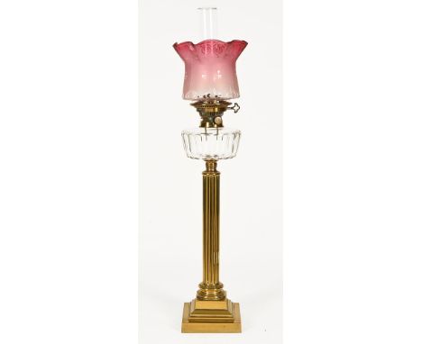 Late 19th century oil lamp, with brass Corinthian column base, clear glass reservoir, Kinks 2 Duplex burner etched ruby glass