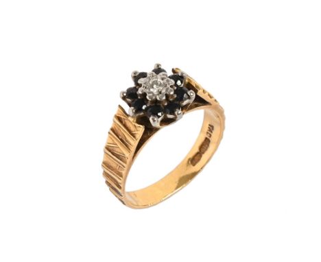 An 18 ct gold diamond and sapphire ring  Size M, weight 4.6 grams.