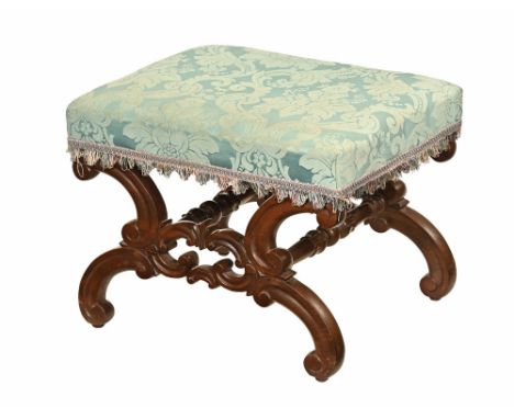 A 19th century mahogany footstool, with blue foliate patterned stuffover top and scroll supports and legs united by stretcher