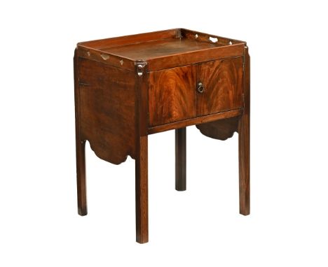 A George III mahogany tray top bedside cabinet, with pair of doors and all raised on moulded legs (converted from commode).  