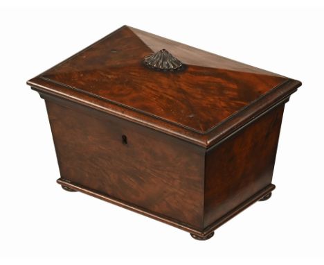 A Regency mahogany tea caddy, with carved knob handle to the angled top with two interior lead lined canisters.  Height 18 cm