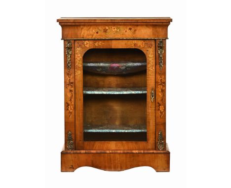 A Victorian foliate marquetry side cabinet, with single glazed door opening to shelves with brass mounts and raised on bracke