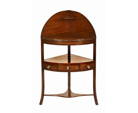 A George III mahogany corner washstand, with single drawer and dummy drawers and with shaped low shelf.  Height 110.5 cm, wid