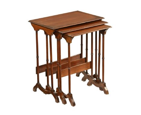 An Edwardian inlaid mahogany nest of three tables, with ring turned supports and sledge feet.  Tallest 70 cm, width 60.5 cm, 