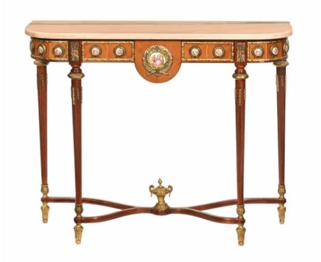 A pink marble topped console table, the frieze with applied ceramic medallions and with rounded corners and raised on four tu
