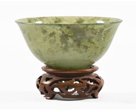 A Chinese jade small bowl on wooden stand.  diameter 10 cm, height 5.3 cm excluding stand.