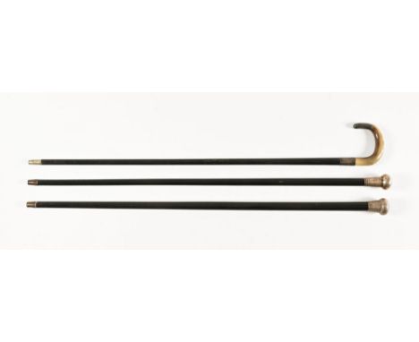 Two ebonised walking canes, with silver hallmarked tops Birmingham 1889 and London with rubbed mark.  Lengths 90 cm and 92 cm