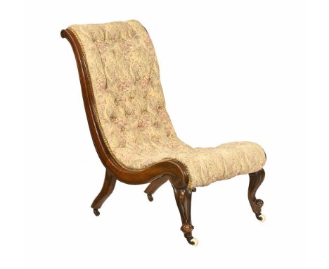 A Victorian mahogany chair, of low form with deep buttoned back and seat with exposed showframe and raised on cabriole legs a