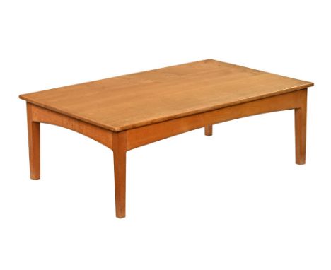 A Peter Hall of Staveley Craftsmen made oak coffee table, with plate glass protective top and raised on tapered chamfered leg
