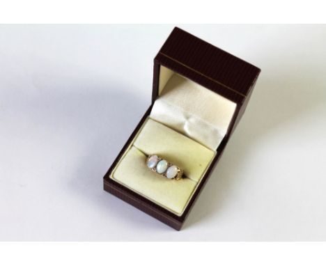 A 9 ct gold three stone opal ring, Size N, weight 5.4 grams.