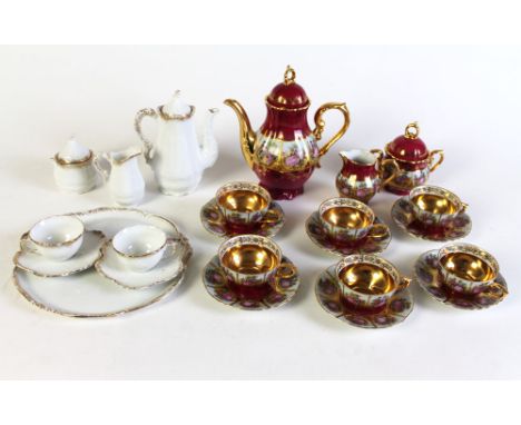 A late 19th/early 20th century coffee service for two, including tray, coffeepot, two cups, two saucers, sucrier and milk jug