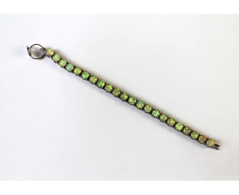 A vintage opal bracelet, containing 22 opals set in white metal.