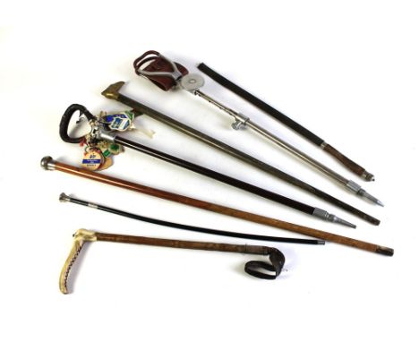 A silver topped cane, various walking sticks, shooting stick etc.