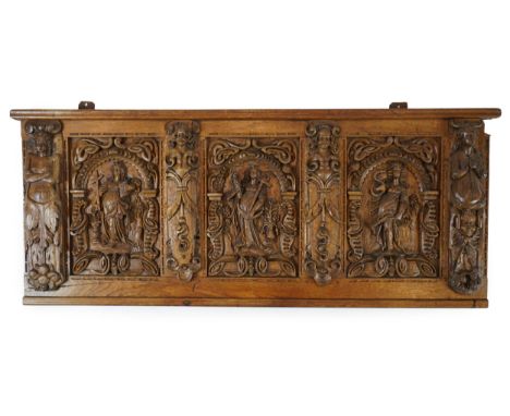 A 17th century and later Flemish carved oak panel with three arched sections carved with the three virtues, personified as wo