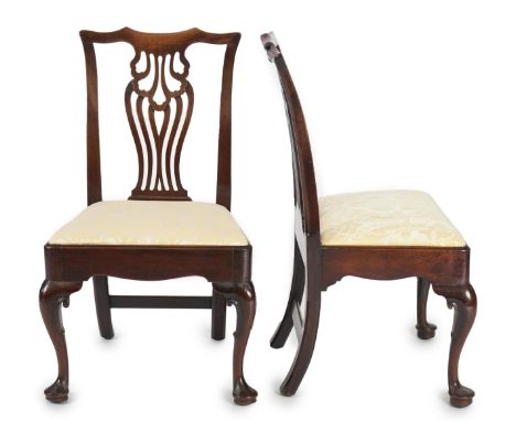 A set six George II mahogany dining chairs with pierced splats and drop in seats on scrolled cabriole legs with pad feet, 57c