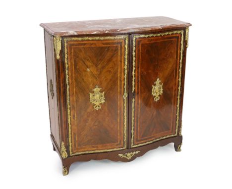 * * A Louis XV ormolu mounted rosewood and tulipwood Meuble d’Appui, with a serpentine fronted Rouge de Maine marble top, the