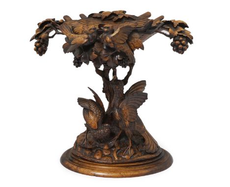 A 19th century Black Forest carved wood centrepiece with vineous basket centred with lovebirds over a tree trunk stem, with g