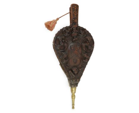 A pair of 17th century carved walnut and oak bellows, the front carved with heraldic motifs and a leopard's head armorial ove