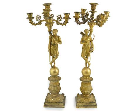After Pierre-Philippe Thomire (1751-1843). A pair of Regency French Empire five light candelabra with ornate scrolling branch