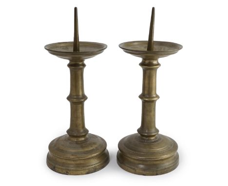 A pair of 16th century bell metal pricket candlesticks with ring turned stems and feet, 16cm diameter, 39cm high Good untouch